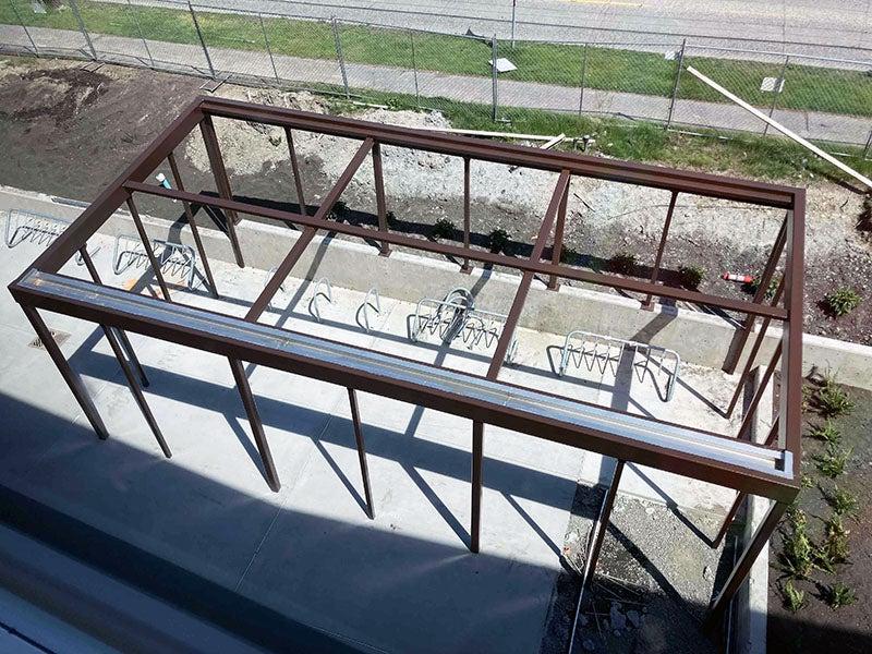 a view from above of a metal framed space with bike racks inside